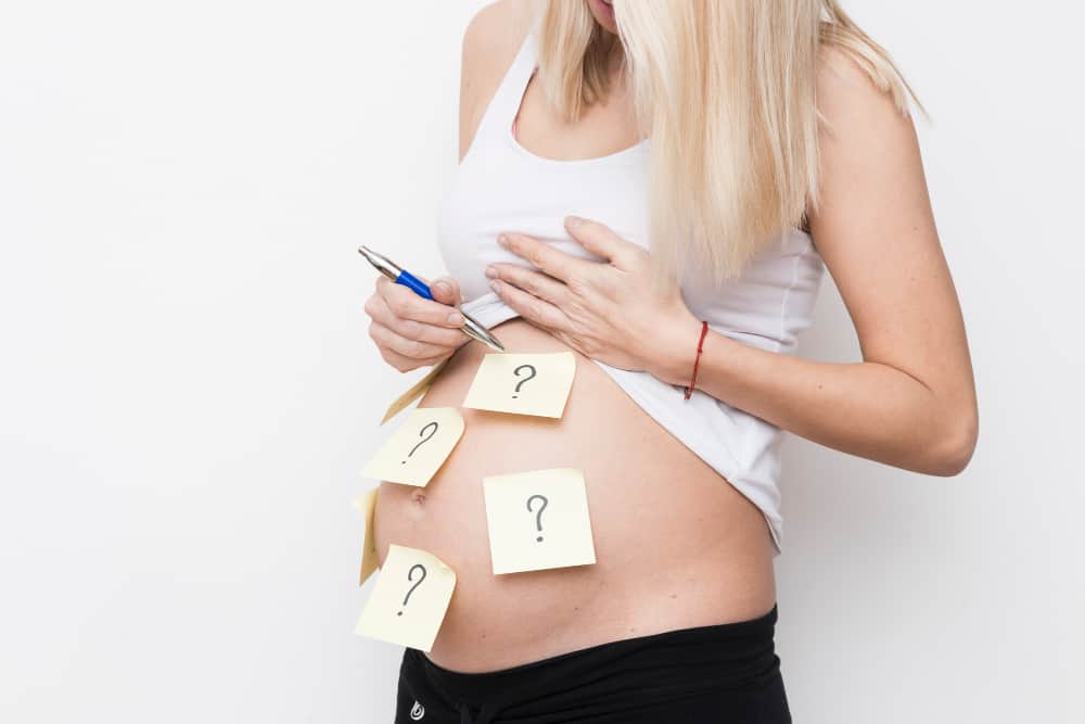 Pregnant woman talking with healthcare provider during a prenatal visit