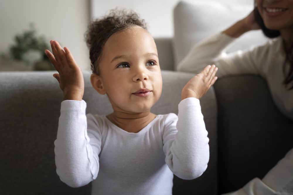 Baby babbling and smiling while a parent talks back