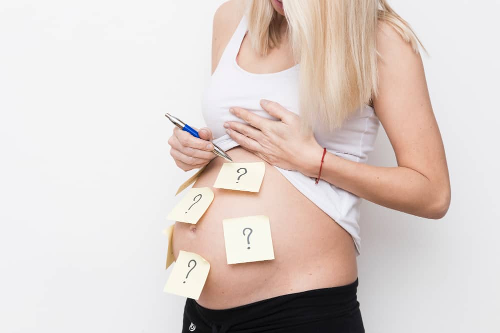 Pregnant woman talking with healthcare provider during a prenatal visit