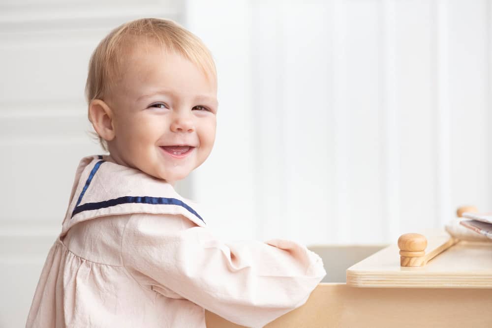 Soft pastel background with flowing letterforms representing gentle baby names