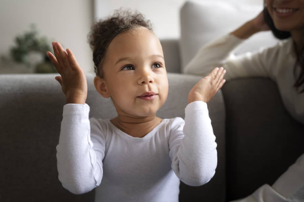 Baby babbling and smiling while a parent talks back