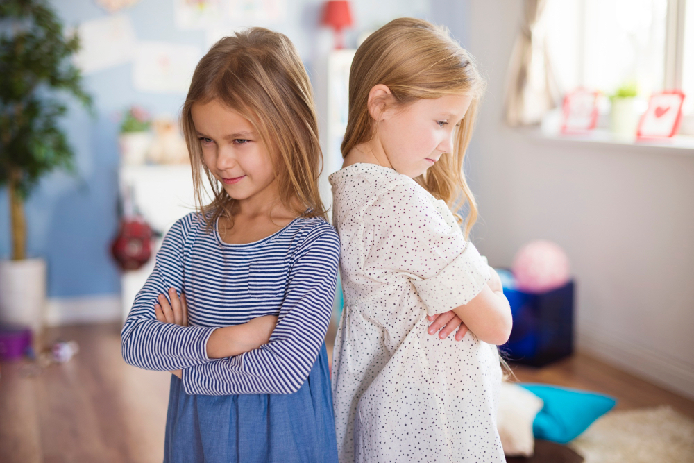 Parent calmly talking with a child at eye level in a supportive home setting