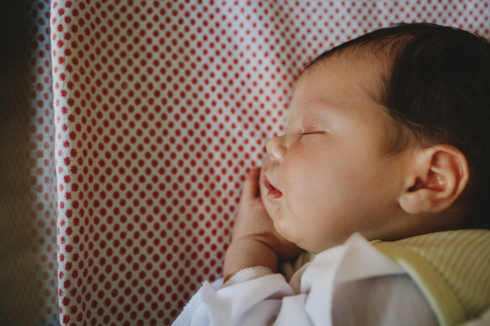 Peacefully sleeping baby wrapped in a soft blanket